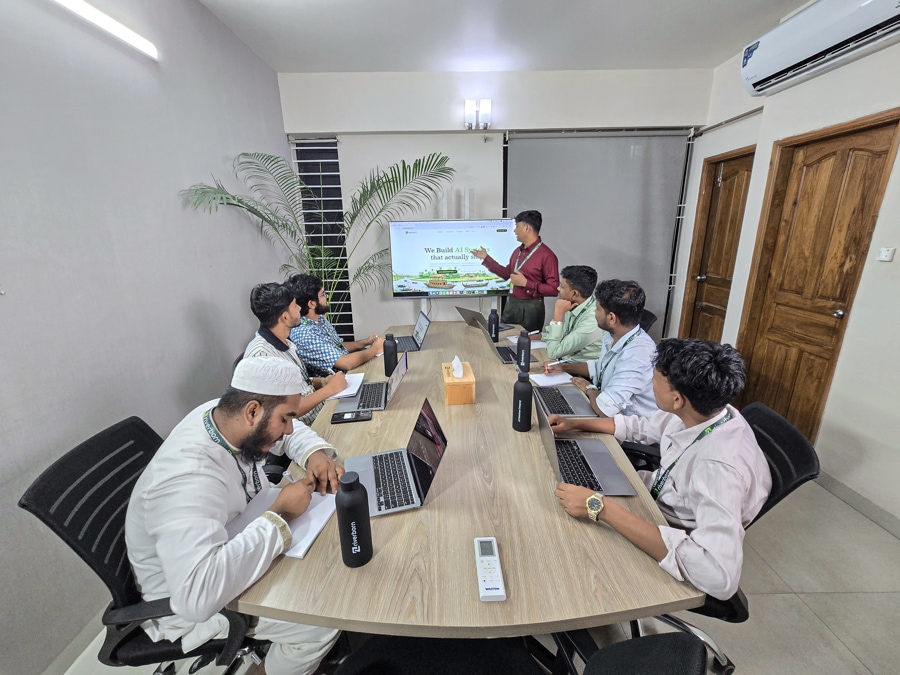 Nasim in team meeting at Riverborn's Dhaka office